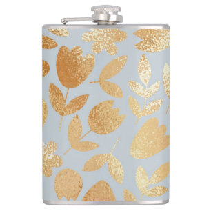 Gold flowers, blue background, foil imitation. hip flask