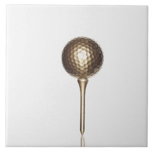 Gold golf ball and tee tile
