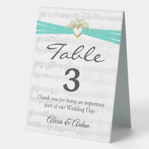 Gold Heart with Aqua Ribbon On Sheet Music
