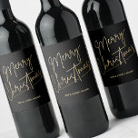 Gold Merry Christmas Black Wine Label<br><div class="desc">Merry Christmas in a faux gold foil script and your names in chic lettering,  these black wine bottle labels are stylish for Christmas gifts or to label wine served at your holiday occasion.</div>