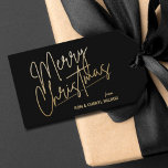Gold Merry Christmas Luxe Black Gift Tags<br><div class="desc">Merry Christmas in a faux gold foil script and your names in chic lettering,  these black gift tags or party favor tags are stylish for any Christmas holiday occasion.</div>