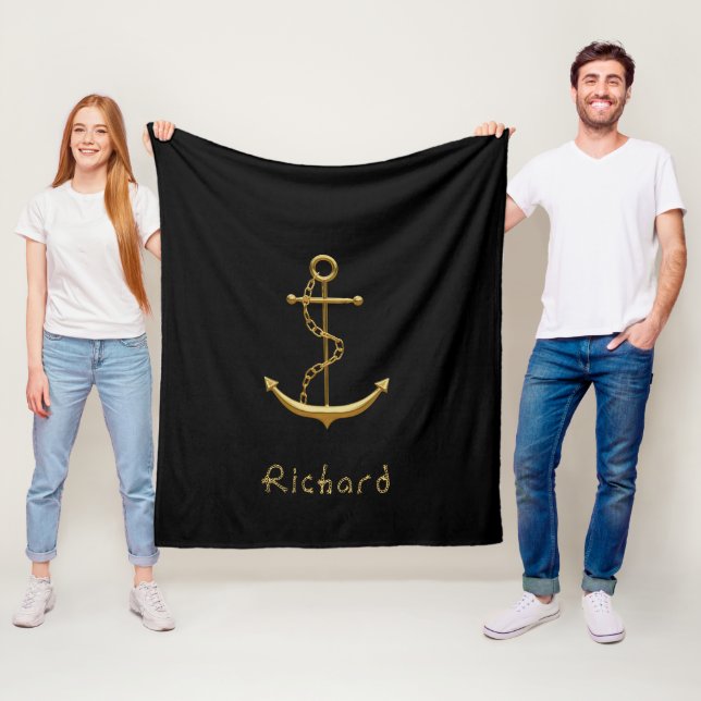 Gold nautical anchor on black custom name fleece blanket (In Situ)