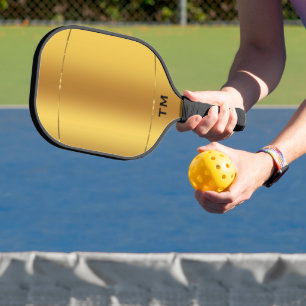 Gold tones background, shiny gold stripe pickleball paddle