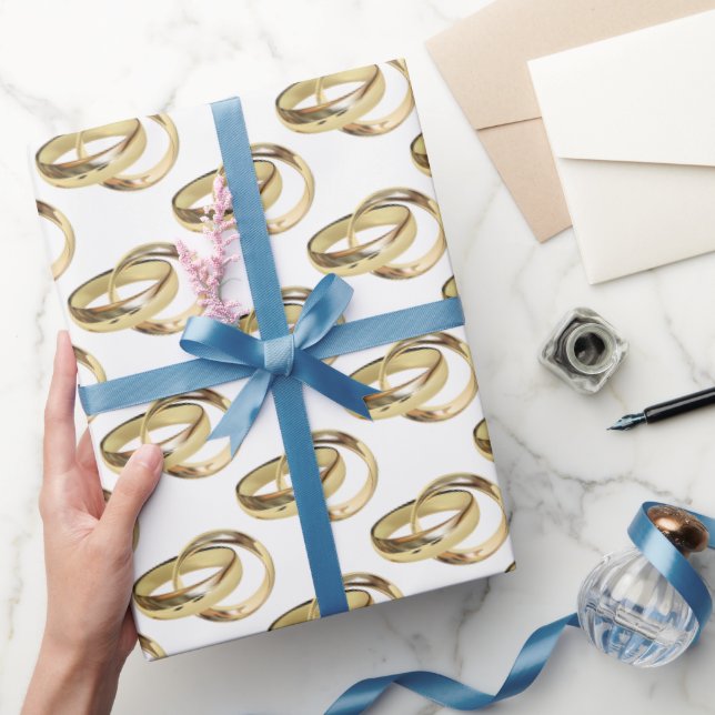 Gold Wedding Rings On White Wrapping Paper (Gifting)