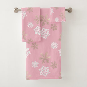 golden and white snowflakes against pale pink bath towel set
