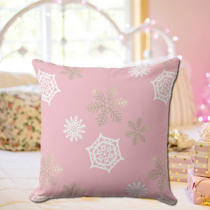 golden and white snowflakes against pale pink cushion