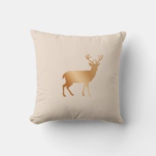 Golden brown reindeer silhouette on beige cushion