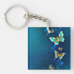 Golden Butterflies on a Blue Background Key Ring
