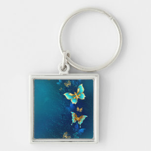 Golden Butterflies on a Blue Background Key Ring