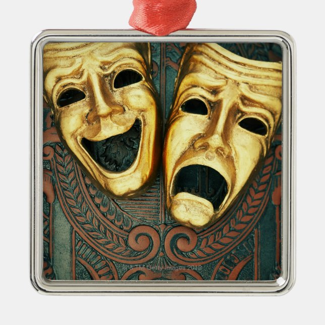 Golden comedy and tragedy masks on patterned metal tree decoration (Front)