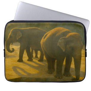 Golden Companions – Elephant Trio in Warm Light Laptop Sleeve