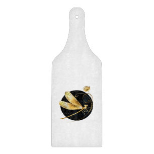 Golden dragonfly in black circle cutting board