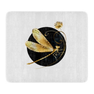 Golden dragonfly in black circle cutting board