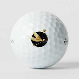 Golden dragonfly in black circle golf balls