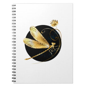 Golden dragonfly in black circle notebook