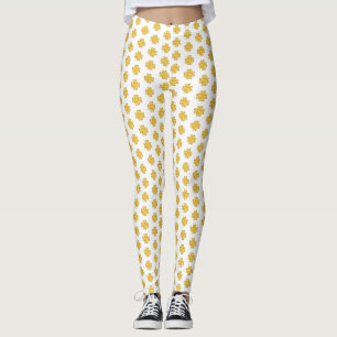 Golden four-leaf clovers on white leggings