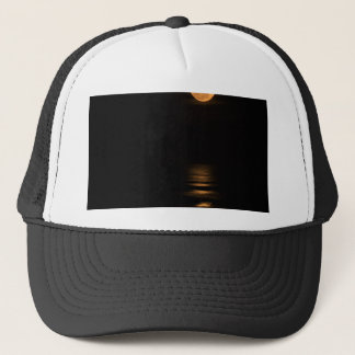golden full moon over ocean trucker hat