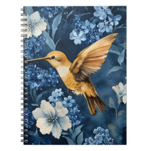 golden hummingbird flying amidst blue and white notebook
