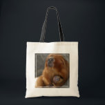 Golden Lion Tamarin with Baby Tote Bag<br><div class="desc">This image shows a young golden lion tamarin being held by an adult. Golden lion tamarins are born fully furred with their eyes open. They cling to their mothers for the first few weeks. All members of the group will carry and care for the infants, but the adult male usually...</div>