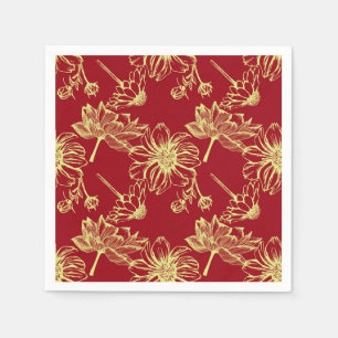 Golden lotus bloom on festive red napkin