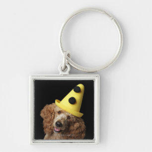 Golden Poodle Dog wearing a yellow clown hat Key Ring