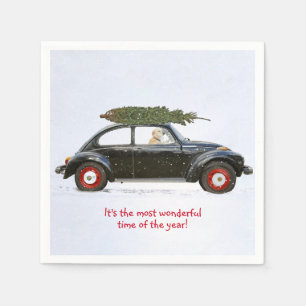 Golden retriever driving old car with holiday tree napkin