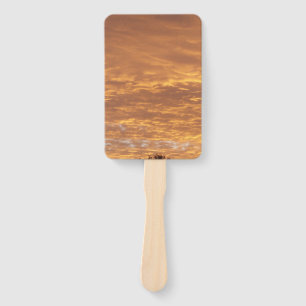 golden sunrise on a hand fan