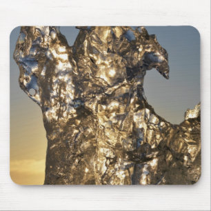 Golden sunrise seen through iceberg formation mouse mat