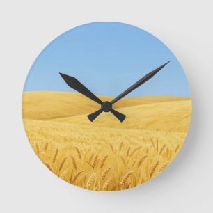 Golden Wheat Field Under Blue Sky Round Clock