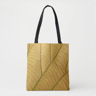Golden yellow leaf pattern in the morning. tote bag