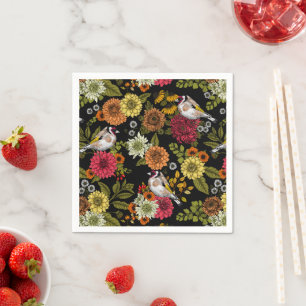 Goldfinches in the garden on black napkin