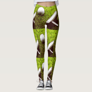 Golf ball and putter on green grass leggings
