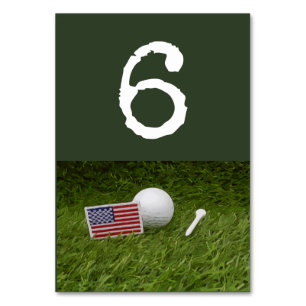 Golf ball and tee with U.S.A. flag on green Table Number