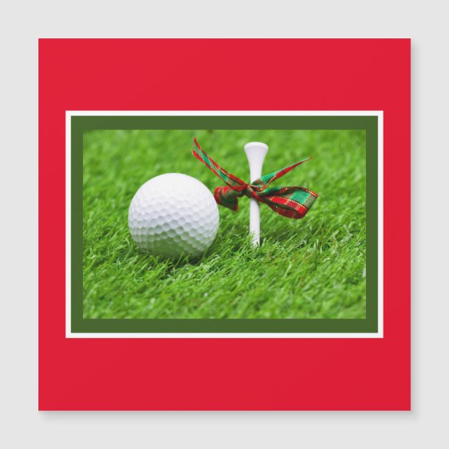 Golf ball Christmas with tee on green grass (Front)