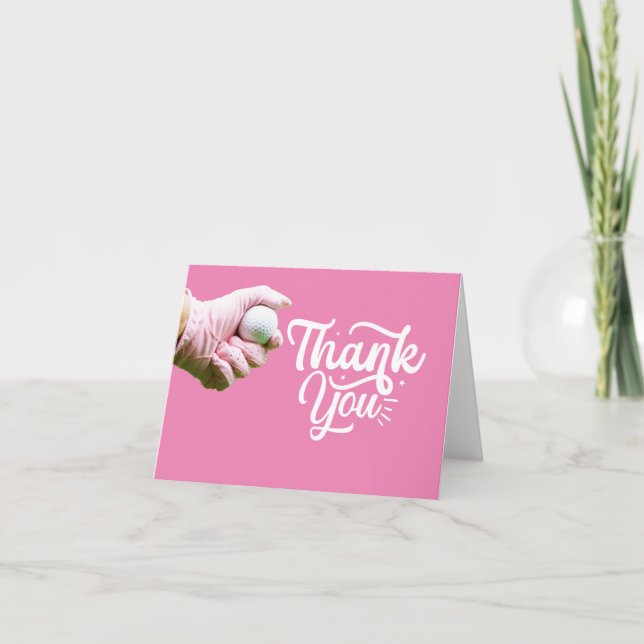 Golf ball is in lady golfer's hand on pink  thank you card (Front)