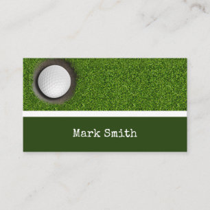 Golf ball is in the hole on green with name business card