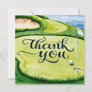Golf ball on putting green with thank you word card