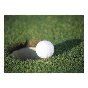 Golf Ball on the edge of hole Photo Print