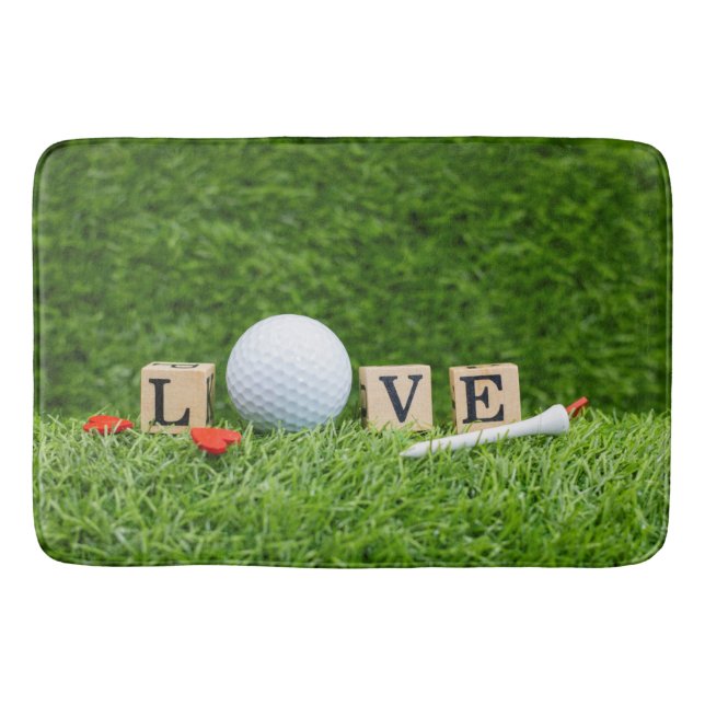 Golf ball with LOVE word and tee on green grass Bath Mat (Front)