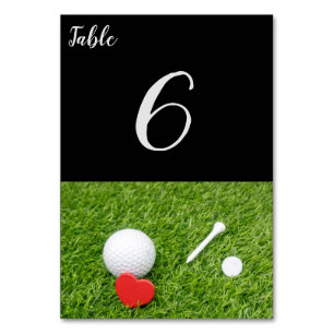 Golf ball with tee and red heart on green wedding table number