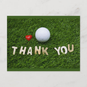 Golf ball with thank you   word on green grass  postcard