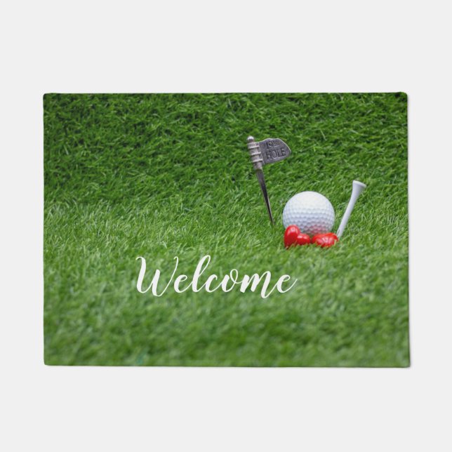 Golf ball with two red hearts are on green grass doormat (Front)