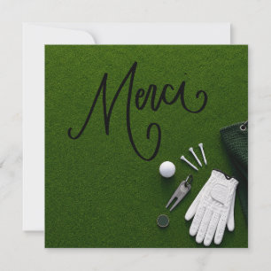 Golf ball with word thank you on putting green card