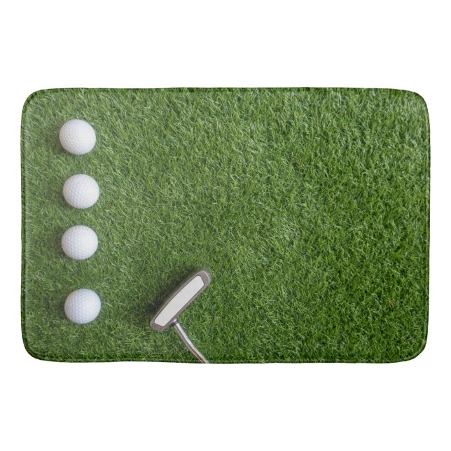 Golf balls are on green grass bath mat (Front)