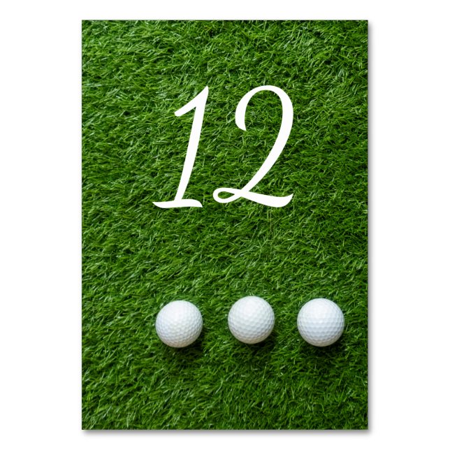Golf balls are on green grass table number (Front)