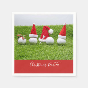 Golf balls with Santa hats Christmas are on green Napkin