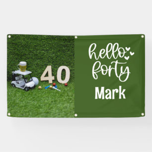 Golf cart is  on green grass 40th birthday banner