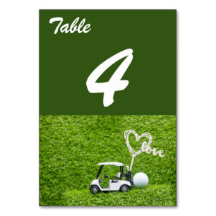Golf cart with love on green grass for wedding table number
