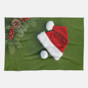 Golf Christmas themed on green grass Tea Towel
