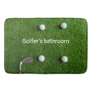 Golfer's bathroom with golf balls on green grass bath mat